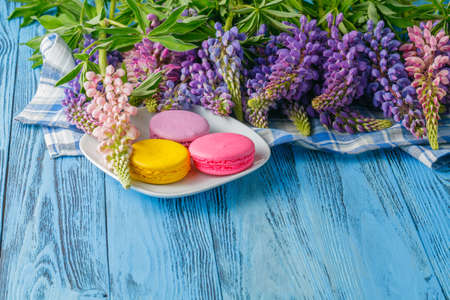 summer flowers and macaroons on tableの写真素材