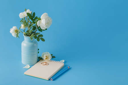 wedding rings and wild roses bouquetの写真素材