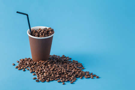 Paper cup with Sleeve on blue background with beans