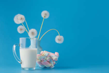 Twisted marshmallow in glass bowl with milkの写真素材