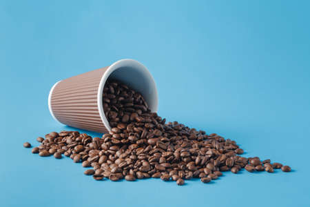 Cup with coffee beans on blueの写真素材