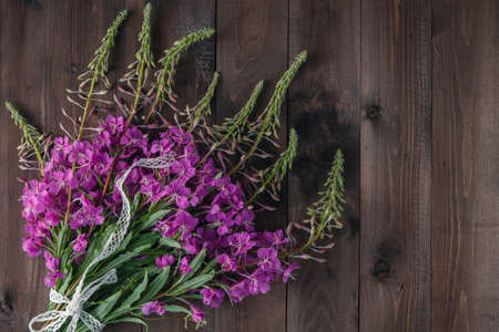 Fireweed flowers fresh on a wooden boards background. Copy spaceの写真素材