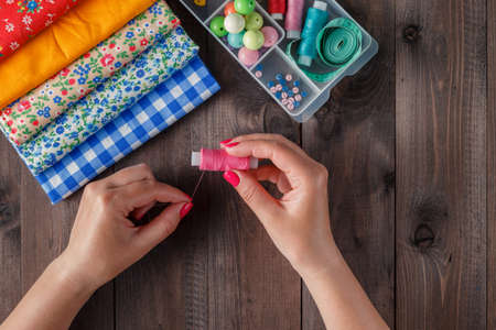Desk of a tailor with various objects, flat viewの写真素材