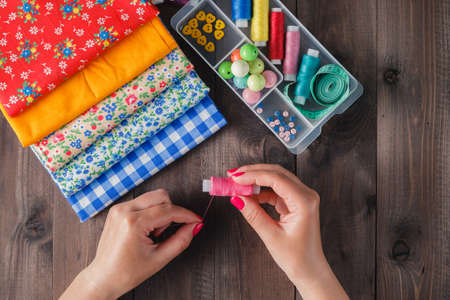 Sewing craft needle textile thread in human fingerの写真素材