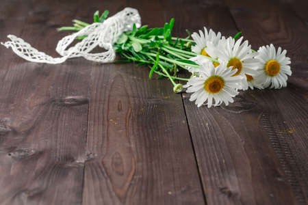 Bouquet of daisy flowers on a wooden backgroundの写真素材