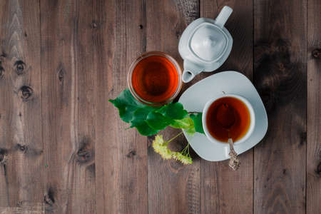 Herbal tea cup with Linden blossom on wooden table, top viewの写真素材