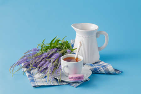 Pastel color macaroon with coffee on blue backgroundの写真素材