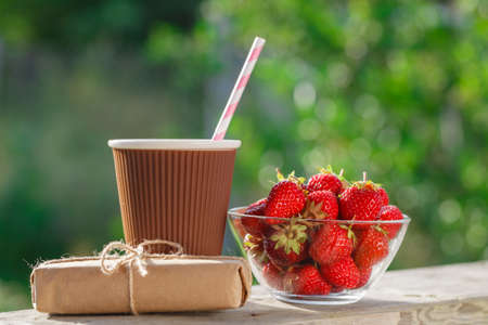 Juicy summer fresh strawberries  on a white wooden background. Breakfast and dessert close-up image with selective focusの写真素材