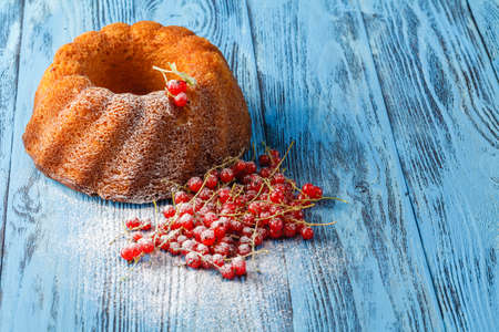 Delicious cakes with red berries on blue tableの写真素材