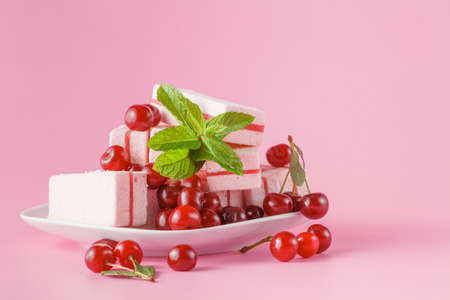fresh cherry on sweets on plate on pink backgroundの写真素材