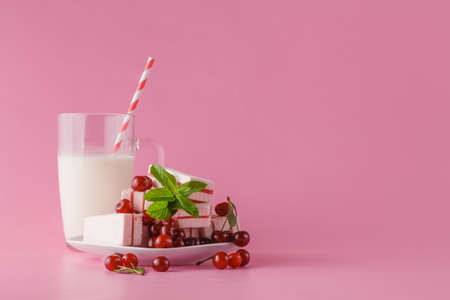 Fresh milk, cherry drink on pink table, assorted protein cocktail with fresh berriesの写真素材