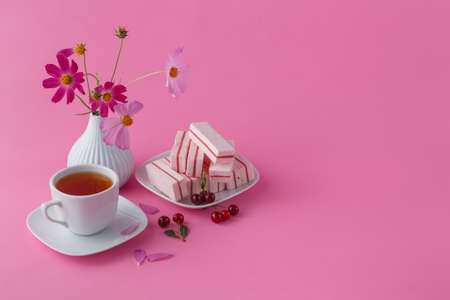 light breakfast or lunch , cherry, berries and black tea on the pink backgroundの写真素材