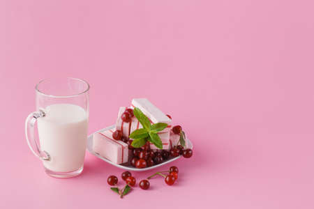 fresh cherry with milk on wood plate on whiteの写真素材
