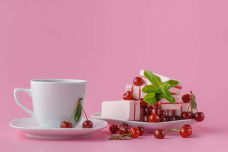 meringue cookie with fresh berries and cup of coffee