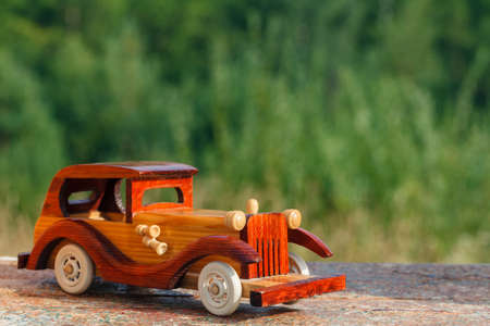 Wooden toy car on a rustic surfaceの写真素材