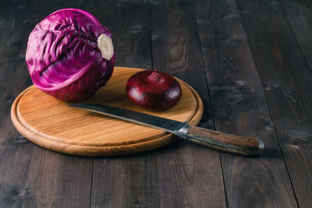 sliced red cabbage red cabbage on old wooden table with knifeの写真素材