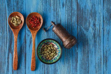 spices and herbs on wooden table with millの写真素材
