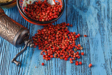 spices sprinkled on the table, pink pepper in bowlの写真素材
