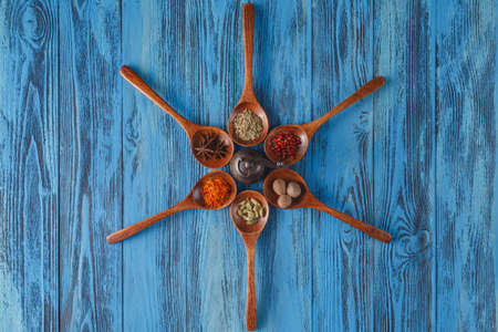 Six spoons full of spices on tableの写真素材