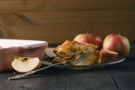 Apple pie with apple slices and crispy crust on a wooden table. Homemade desserts.の写真素材