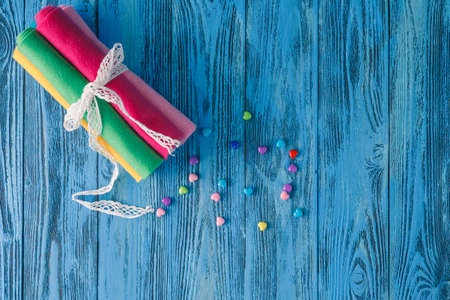 Pieces of cloth, buttons - a sewing kit on blue backgroundの写真素材