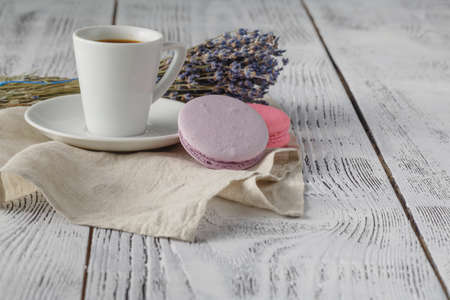 A cup of coffee "espresso", macaroon and a bouquet of lavendeの写真素材