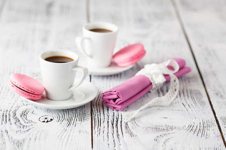 two coffee cups on shabby chic  wooden table in cafeの写真素材