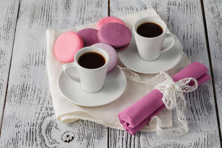 Two cups of espresso with macaroons on rustic table. Morning coffee for couple in loveの写真素材