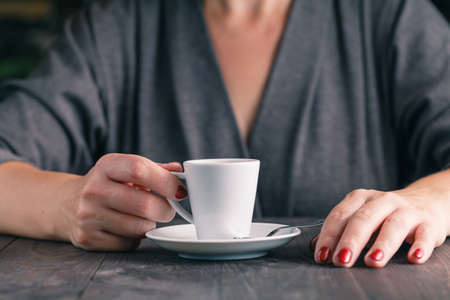 Close up photo of hands and cup of coffeeの写真素材