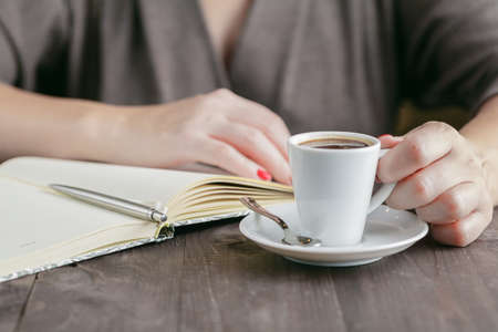 Woman drinking espresso coffee and do morrning planningの写真素材