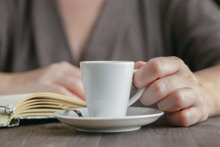 Woman drinking a cup of hot coffeeの写真素材