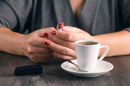 woman ready to rouge lip after espresso coffeeの写真素材