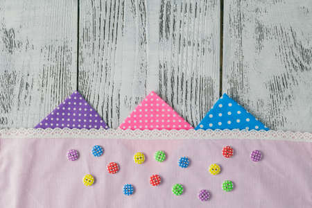 cotton fabrics for sewing, lace and accessories for needlework on wooden background. Set for needlework top viewの写真素材