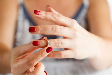 Woman is taking off the ring from hand