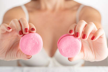 Tasty colorful macaroons in female handsの写真素材
