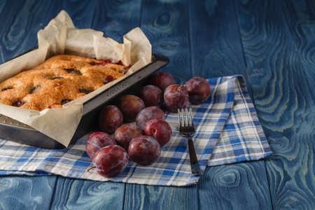 Finished pie of plumes and peaches on the wood desk and blue backgroundの写真素材