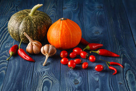 Fall background with pumpkins on blue wooden background with copy spaceの写真素材
