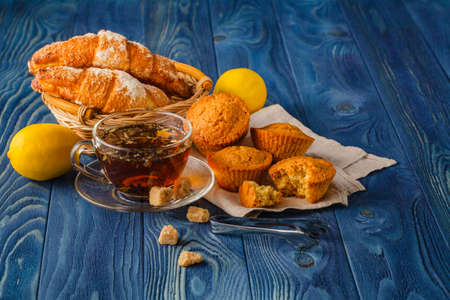Freshly brewed helpful tea with in a glass cup on a wooden tableの写真素材