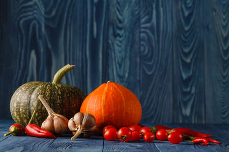 Fresh pumpkins on a wooden tableの写真素材