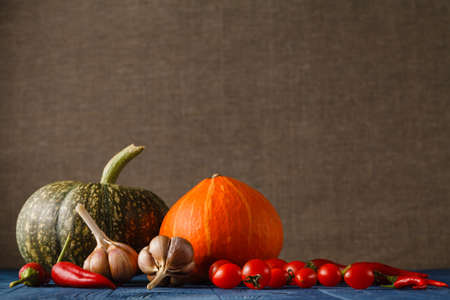 Autumn still life with pumpkins and leaves on old wooden backgroundの写真素材