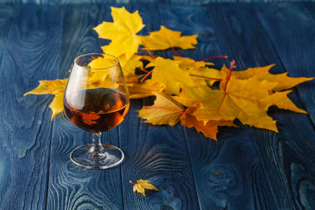 Autumn relaxing scene with glass of whiskeyの写真素材