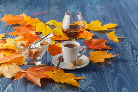 goblets of brandy and cup of hot coffeeon wooden old counter topの写真素材