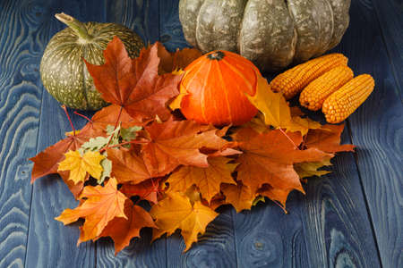 hanksgiving - different pumpkins in rattan basket in front of old weathered wooden boards iの写真素材