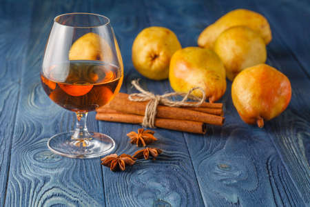traditional fruit brandy and pears on a vintage grunge wooden backgroundの写真素材