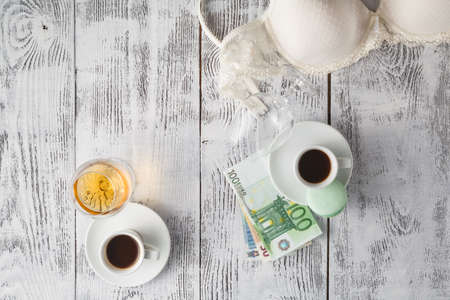 Romantic evening, coffee, cognac and undressed bra on tableの写真素材