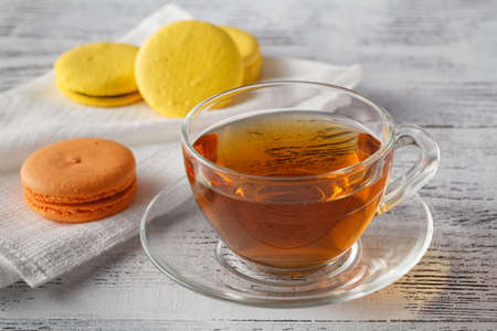 Sweet and colourful french macaroons with tea cupの写真素材