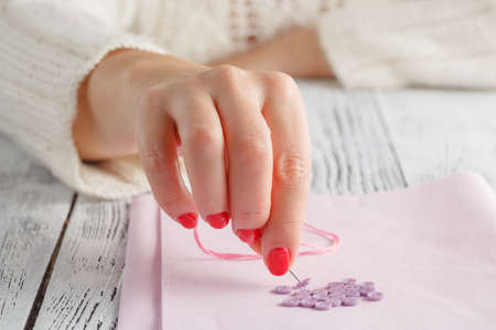 hand hold needle sew a button
