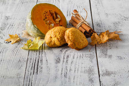 Spice pumpkin homemade cookies against wood background with ingredientsの写真素材