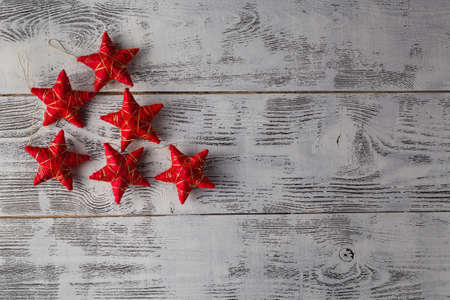Christmas decoration.Red Christmas stars on rustic dark wooden backgroundの写真素材