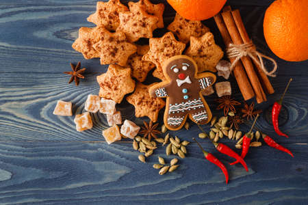 Christmas gingerbread cookies and spices on wooden background. Close-upの写真素材
